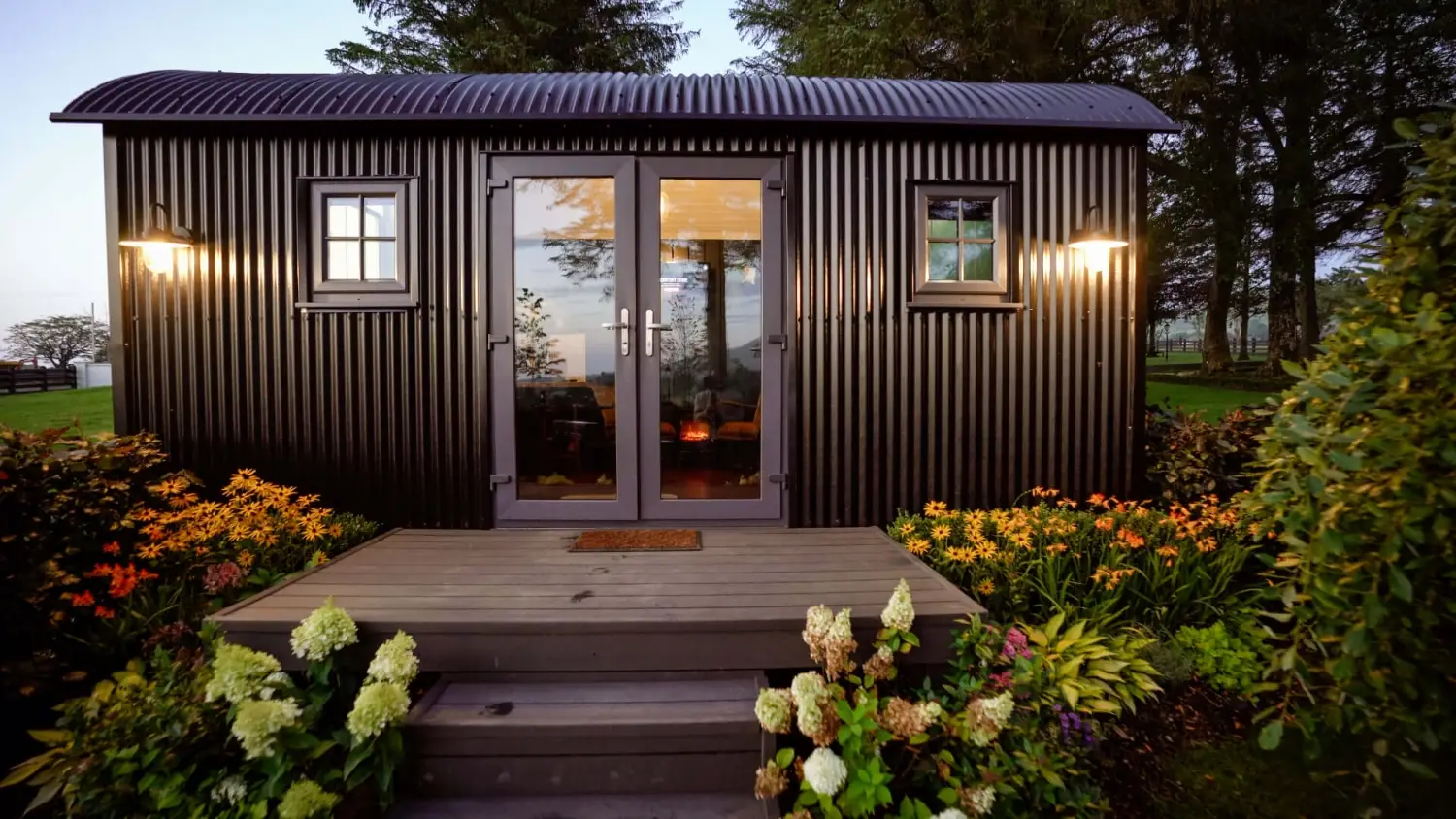 Shepherds Hut exterior with steps and lantern